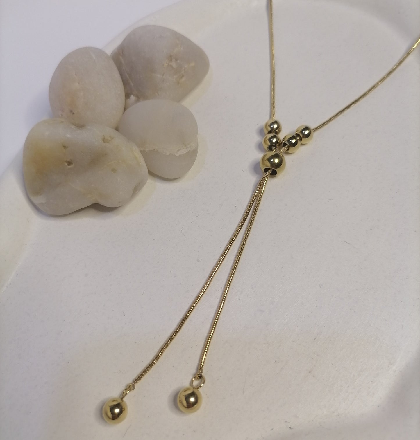 CD031 | Colgante regulable con esferas macizas en acero dorado