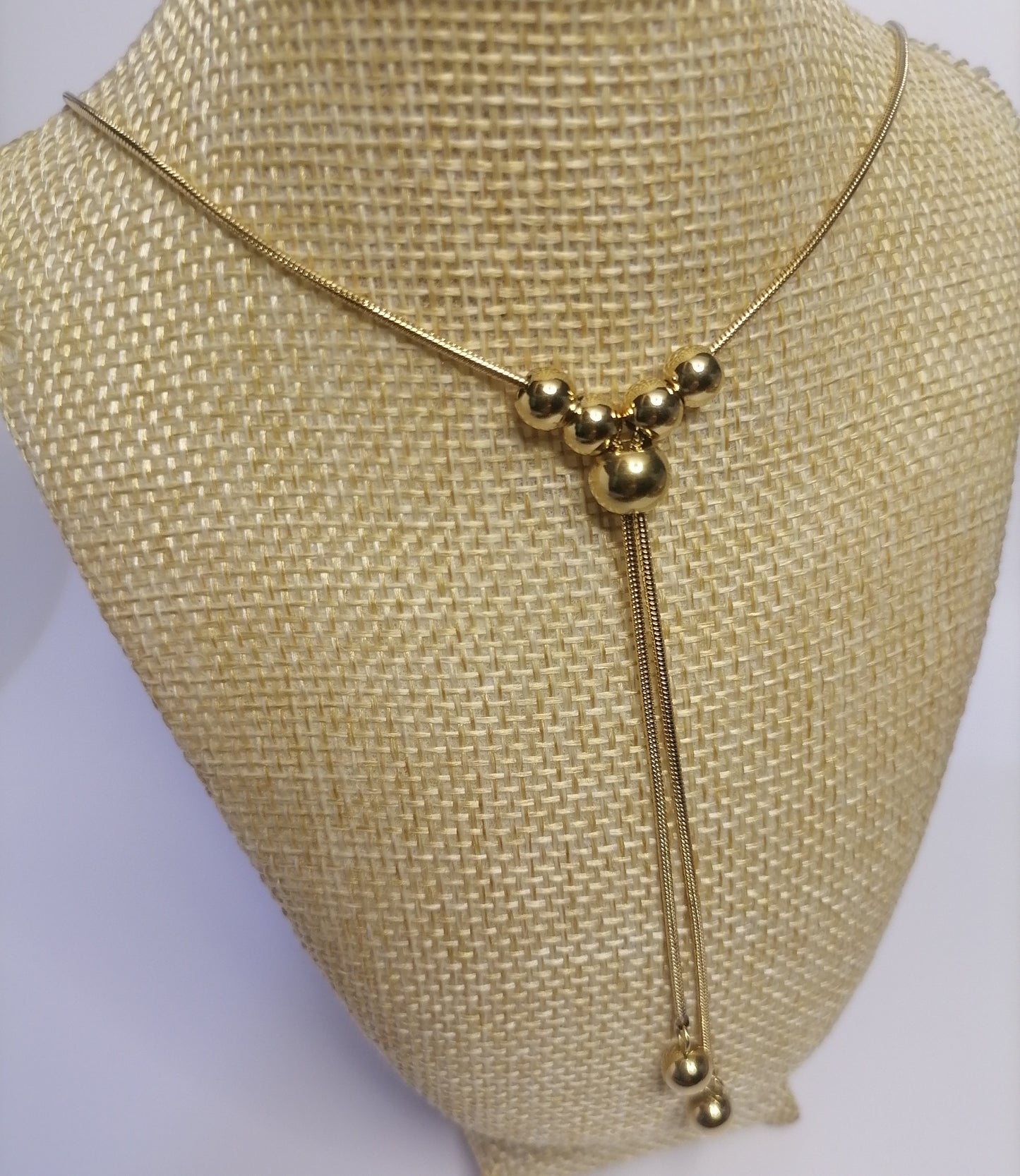 CD031 | Colgante regulable con esferas macizas en acero dorado