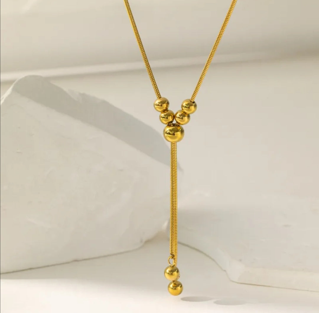 CD031 | Colgante regulable con esferas macizas en acero dorado