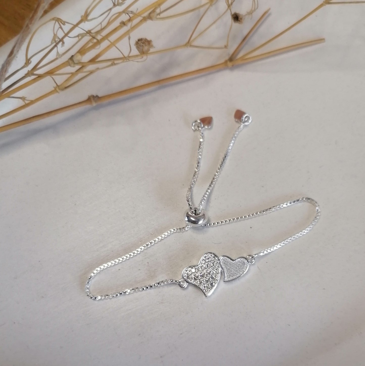 PQ042 | Pulsera ajustable en acero blanco dos corazones y circonias