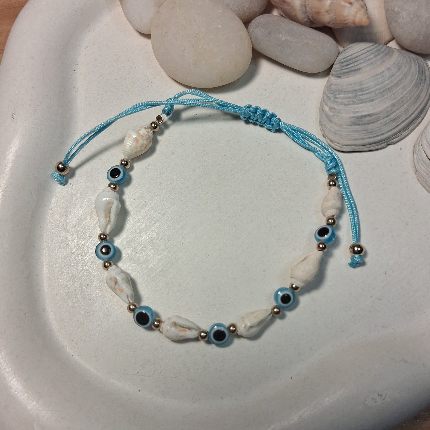 TB003 | Tobillera ajustable ojitos protectores y caracoles